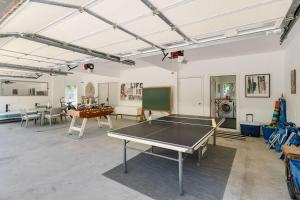 a room with a ping pong table in it at Camp Magic 1 in Hanalei