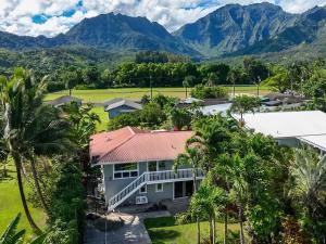 an aerial view of a house with mountains in the background at Camp Magic 1 in Hanalei