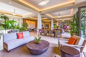 a living room with a couch and a table at Whaler 102 in Lahaina