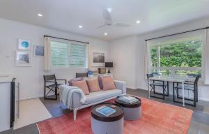 哈纳莱伊Pinetrees Hanalei Cottage的客厅里有一张沙发和一张桌子。