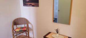a room with a chair and a mirror and a table at Ferienwohnung mit großer Terrasse in Boppard