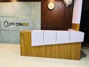 a clock on a wall next to a box at City Centre in Coimbatore