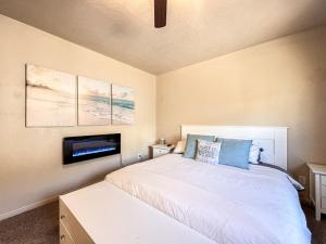 a bedroom with a bed with a tv on the wall at Bear Lake Escape-Pet Friendly in Garden City +40 photos