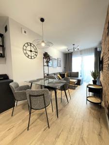 una sala da pranzo e un soggiorno con tavolo e sedie di Baltic Waves Resort Międzyzdroje - Apartament A014 a Międzyzdroje