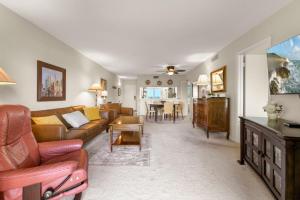 a living room with a couch and a table at Charming 2-Bedroom, 2-Bath Condo with Golf Course Views in Isla Del Sol in Point Brittany