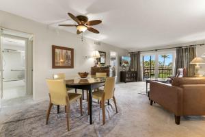 a dining room and living room with a ceiling fan at Charming 2-Bedroom, 2-Bath Condo with Golf Course Views in Isla Del Sol in Point Brittany