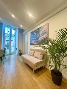 a living room with a couch and a plant at Sottolavolta in Lecce +26 photos