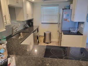 a kitchen with a sink and a refrigerator at 202 - Adorable 1 bedroom unit - sleeps 6 in Edgewater +34 photos