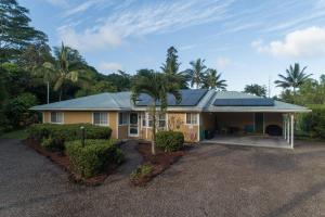 a house with a solarium on top of it at Hale O Makani in Keaau