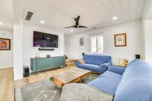 a living room with a blue couch and a table at Deck and Scenic Views Lakefront Cottage in Hale! in Hale