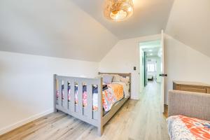 a bedroom with a crib in a room at Deck and Scenic Views Lakefront Cottage in Hale! in Hale