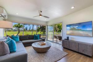 a living room with a couch and a table at Emmalani Court 322 in Princeville