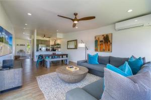a living room with a couch and a ceiling fan at Emmalani Court 322 in Princeville