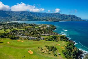 an aerial view of a golf course next to the ocean at Emmalani Court 322 in Princeville