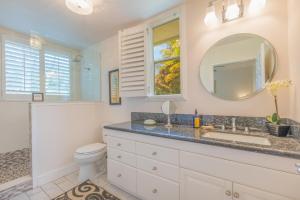 a bathroom with a sink and a toilet and a mirror at Hale Emmalani #311 in Princeville +8 photos
