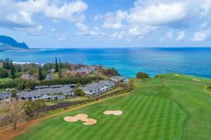 an aerial view of a golf course with the ocean at Hale Emmalani #311 in Princeville