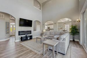 a living room with a couch and a tv at Sunset Valley in Kirk O'Cliff
