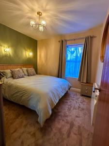 une chambre avec un grand lit et une fenêtre dans l'établissement 27 By The Sea, à Ballycastle