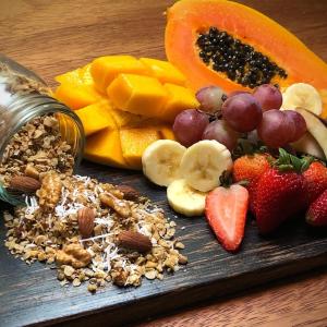 a plate of fruit and nuts on a table at Coral Tree Lodge Tena in Tena