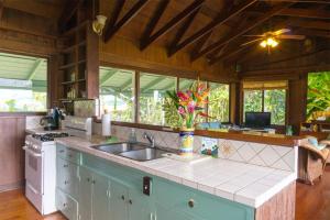 a kitchen with a sink and a counter top at Wainiha Beach Hale in Wainiha