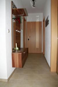 a hallway with a bathroom with a sink and a mirror at Jürgen Ferienwohnung in Wernigerode