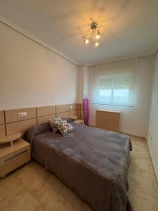 a bedroom with a large bed and a window at Apartamento Magic World, nueva Marina Dor, Jardines del Mar III- Oropesa del Mar in El Borseral