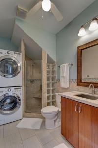 a bathroom with a washer and a toilet and a sink at Paradise Ocean View in Keaau +30 photos
