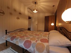 a bedroom with a bed with a comforter on it at Noor House 1 in Şuncuiuş