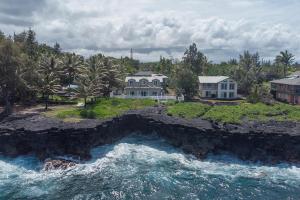 an aerial view of a house next to the water at Paradise Ocean View in Keaau