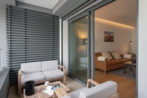 a living room with white chairs and a couch at With pool in Funchal - Acqua Residence V in Funchal