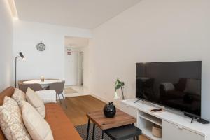 a living room with a large flat screen tv at With pool in Funchal - Acqua Residence V in Funchal