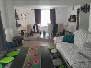 a living room with a couch and a dining room at Casa Nico Nelu Duplex in Arieşeni