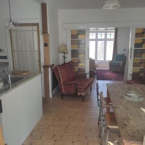 a kitchen and living room with a table and chairs at Seaside Retreat Guest Suite - Encil ger y môr in Aberystwyth +16 photos