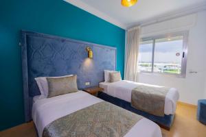 Postel nebo postele na pokoji v ubytování Moroccan Floors - Suites Appart-Hôtel