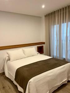 Ένα ή περισσότερα κρεβάτια σε δωμάτιο στο Apartamentos HORNOS