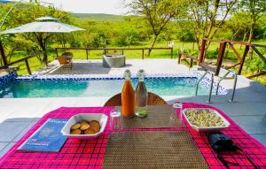 a picnic table with a tray of food on a pink blanket at Kitumo Mara Lodges in Mara Simba