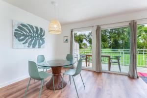a dining room with a table and chairs at Emmalani Court 423 in Princeville