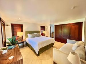 a bedroom with a bed and a couch at Hale Aku in Hanalei