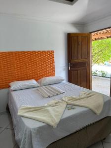 a bedroom with a bed with two towels on it at Pousada Casa Grande in Barreirinhas +70 photos
