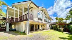 a large white house with a yard at Hale Aku in Hanalei