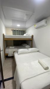a room with three bunk beds in it at Hotel Casablanca in Galapa