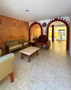 a room with benches and tables in a building at Suites Cancun Center in Cancún +68 photos