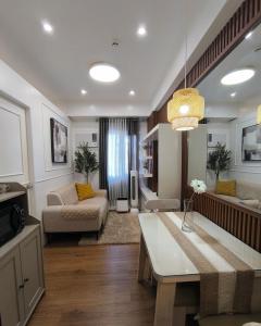 a living room with a couch and a table at Casita Isleta at Cheer Residences in Marilao