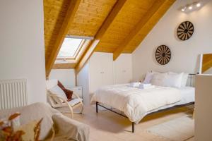a bedroom with a bed and a chair in a attic at Rokani Sofita I at Kalavrita Center in Kalavrita