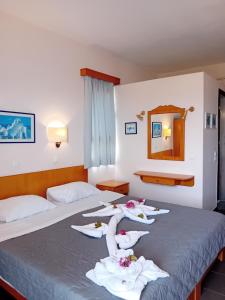 A bed or beds in a room at Heliotopos Apartments