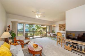 a living room with a flat screen tv and a couch at Lae Nani 434 in Kapaa