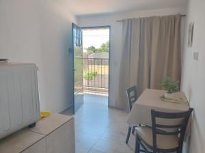 a dining room with a table and a balcony at El Tata in Recreo