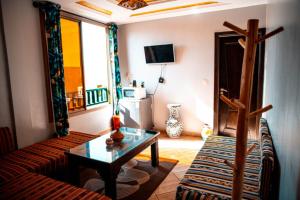 a living room with a couch and a table at Imsouane petitsurfer SurfCamp & Yoga in Imsouane