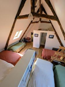 a attic room with two beds and a loft at La Barbotierre 10 Personnes en bord de mer in Cherrueix +38 photos