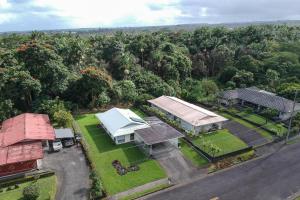 an overhead view of a house with a road and trees at Hilo Hale Kaumana in Hilo